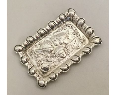 A rectangular silver pin tray mounted with cherubs. Birmingham 1904. Approx. 25 grams. Est. £30 - £40.