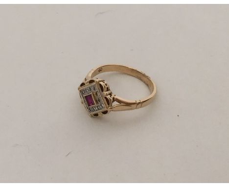 An attractive 18 carat ruby and diamond cluster ring with scroll decoration. Approx. 4.1 grams. Est. £120 - £150.