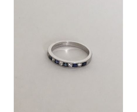 An attractive sapphire and diamond half eternity ring in 18 carat gold rubover mount. Approx. 3.6 grams. Est. £80 - £120.