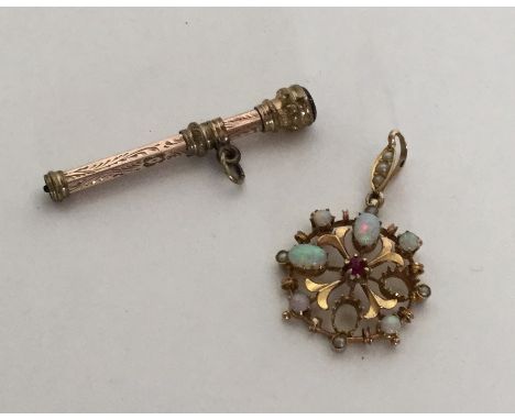 A small gold extending pencil together with an opal mounted brooch. Approx. 5 grams. Est. £30 - £40.