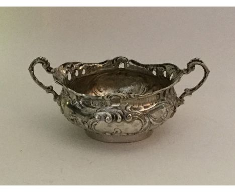 A good quality miniature silver two handled cup with scroll decoration. Approx. 44 grams. Est. £30 - £40.