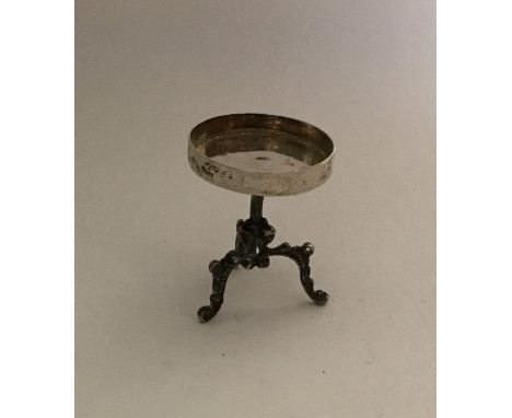 An unusual Continental silver miniature table. Marked to reverse. Approx. 16 grams. Est. £25 - £30.