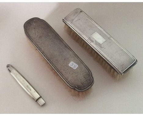 Two silver engine turned brushes together with a Sampson Mordan pencil. Est. £15 - £20.