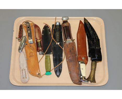 A group of modern hunting and military style knives.