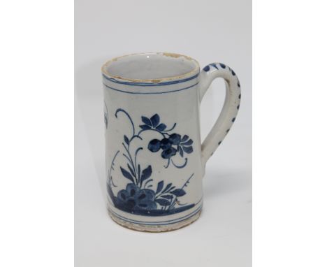 An 18th century blue and white delft mug, height 18 cm.  CONDITION REPORT: Numerous typical nicks and chips, plus a hairline 
