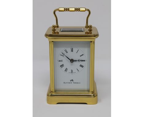 A modern brass cased Matthew Norman carriage clock, with enamel dial and platform escapement, height 14.5cm above handle. 