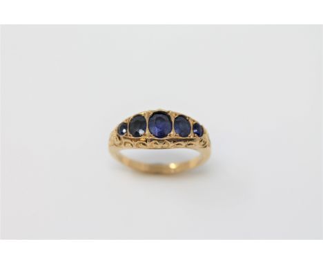 An 18ct gold five stone sapphire ring, size K, 2.9g.