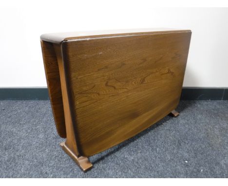 An Ercol elm drop leaf gateleg coffee table, width 102cm opened. 