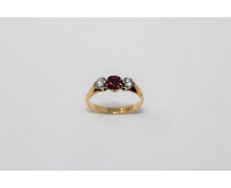 An 18ct gold ruby and two stone diamond ring, size O/P, 3.3g.