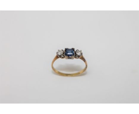 An 18ct gold two stone diamond and sapphire ring, size N, 2g.