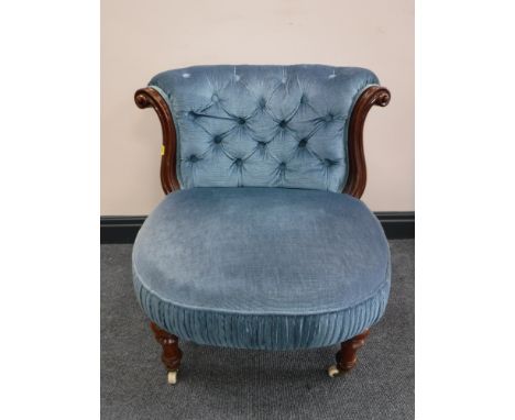 A Victorian mahogany button-back lady's chair, raised on ceramic castors, width 59cm. 