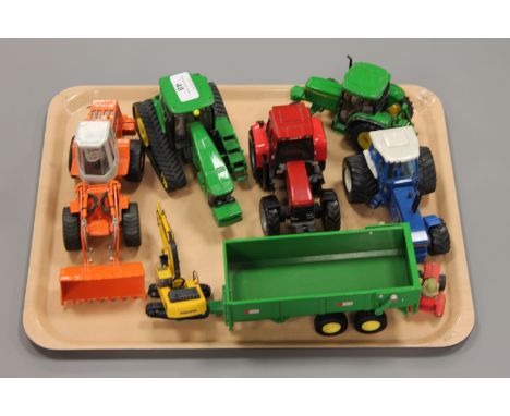 A collection of die-cast farm vehicles including John Deere tractor etc. (Q)