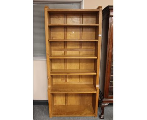 A Robert 'Mouseman' Thompson of Kilburn 6ft oak open bookcase, with solid uprights and a panelled back, the upper section wit