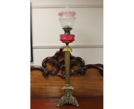 An impressive Victorian brass oil lamp with pink glass shade, height 109cm. CONDITION REPORT: Column and shade likely a marri