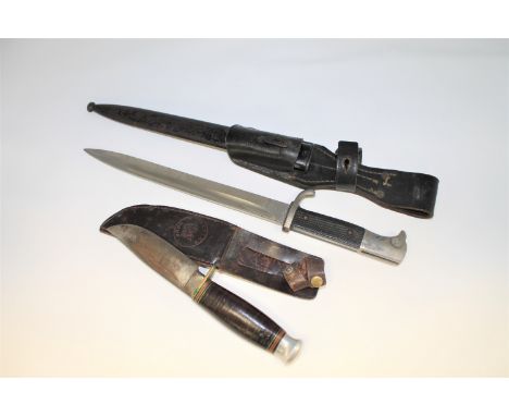 A German bayonet in sheathe, together with a hunting knife stamped 'William Rodgers. I Cut My Way'. (2)