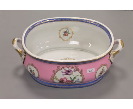 A continental porcelain twin handled basin or foot bath, with blue crossed swords mark to base, width 56cm.