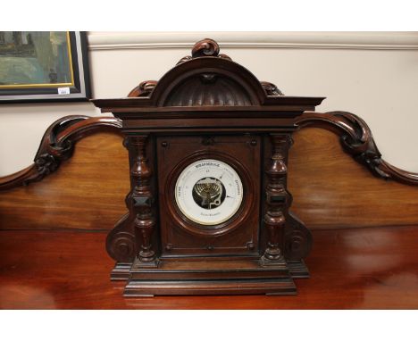 A Victorian aneroid barometer in carved mahogany case. 