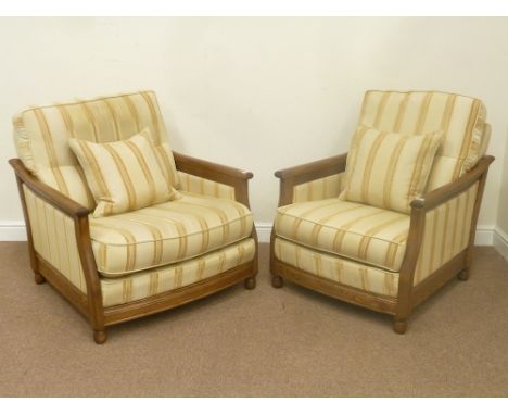 Two ash Ercol 'bergere easy chair' armchairs with upholstered sides in golden dawn and matching cushions, in beige striped fa