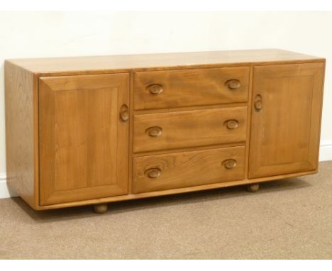Ercol light elm sideboard fitted with three drawers and two cupboards, W156cm, H68cm, D44cm