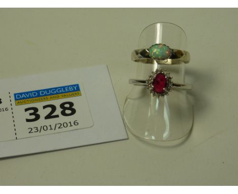 Ruby and diamond cluster ring stamped 925 and a ring set with an opal stamped sterling