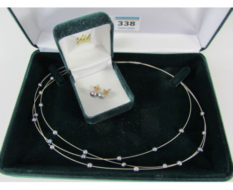White gold black pearl necklace stamped 750 and a pair of  black pearl earrings stamped 375 retailed by John Lewis