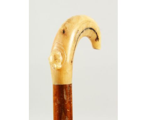 A WALKING STICK with simulated-bone handle. 2ft 1in long.