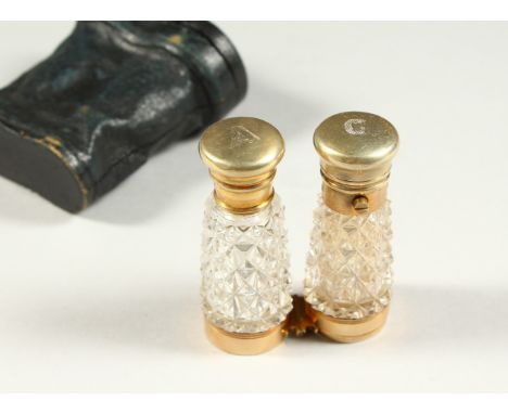 A RARE VICTORIAN CUT GLASS FOLDING DOUBLE ENDED SCENT BOTTLE as a pair of binoculars in a leather case. 12cms long open.