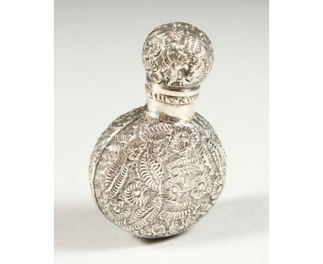 A VICTORIAN CIRCULAR FLASK SHAPED SILVER SCENT BOTTLE AND COVER with allover floral repousse decoration. London 1890. Maker C