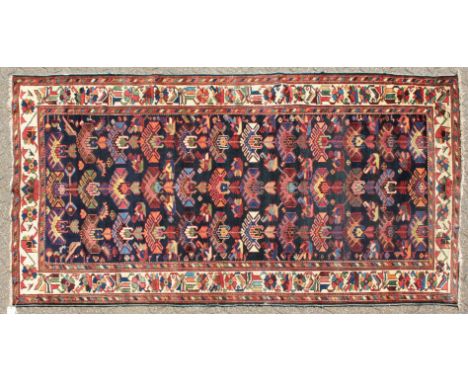 A PERSIAN BAKHTIARI CARPET with numerous designs on a blue ground.9ft 10in x 5ft 0