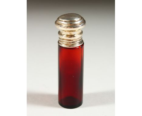 A PLAIN VICTORIAN RUBY GLASS SCENT BOTTLE with silver top. 8.5cms long x 2cms diameter.