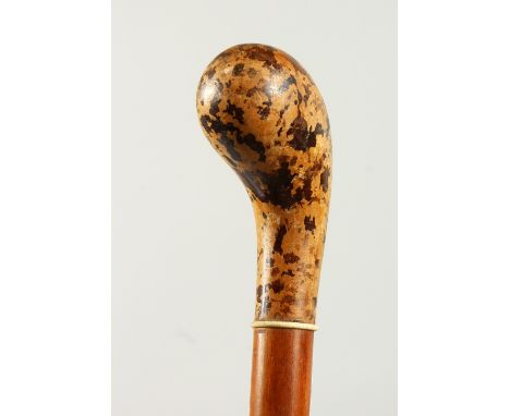 A WALKING STICK with mottled handle. 3ft long.