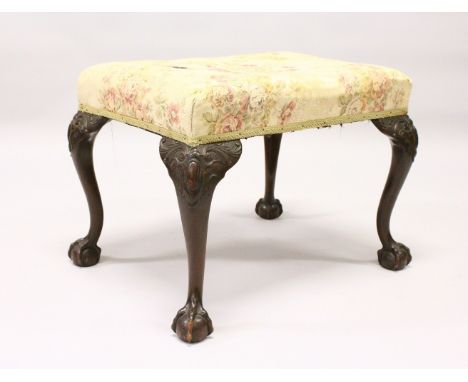 A CHIPPENDALE STYLE MAHOGANY FRAMED STOOL, 20th Century, with overstuffed seat on well carved cabriole legs with claw and bal