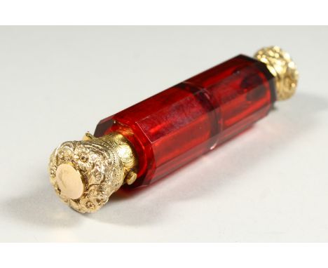 A VERY GOOD VICTORIAN FACET CUT RUBY GLASS DOUBLE ENDED SCENT BOTTLE with silver gilt repousse tops. 12cms long.