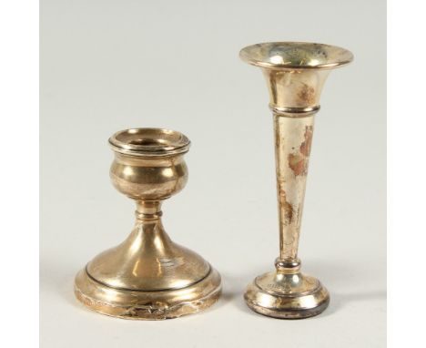 A SINGLE FLUTED FLOWER VASE on a circular loaded base, Birmingham 1996, 4.5ins high and A SQUAT CANDLESTICK, 3ins high (2).