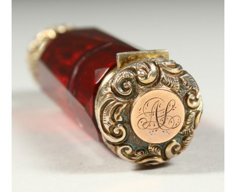 A VICTORIAN RUBY FACET CUT DOUBLE ENDED SCENT BOTTLE with screw off cap, the other end a vinaigrette. 9cms long.