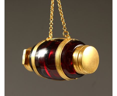 A NOVELTY RUBY GLASS BARREL SHAPED SCENT BOTTLE AND VINAIGRETTE with gilded bands and chain. 6cms long.