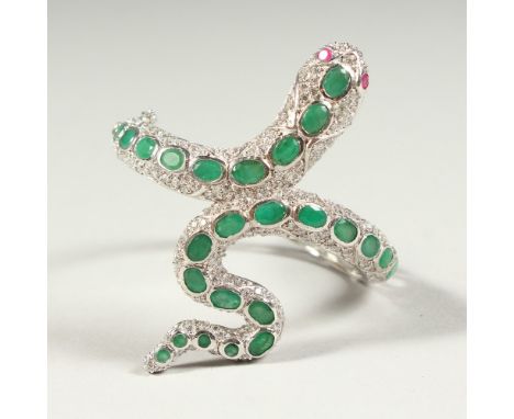 A SILVER AND REAL EMERALD SNAKE BANGLE with ruby eyes.