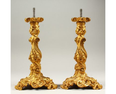 A PAIR OF ORMOLU LAMP BASES in the Rococo style. 26cms high.