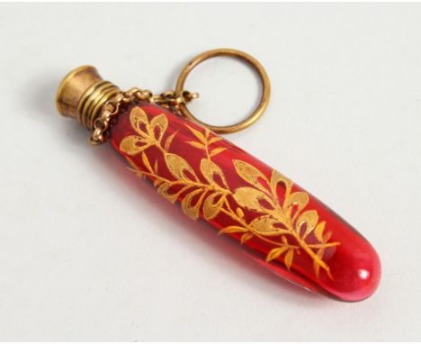 AN ART NOUVEAU RUBY GLASS SCENT BOTTLE decorated with leaves in gilt with plain stopper, gilt metal mount and ring. 8cms long