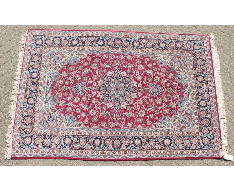 A FINE PERSIAN SILK AND WOOL ISFAHAN CARPET with allover red and blue design.7'7" x 5'2" (230cm x 156cm)