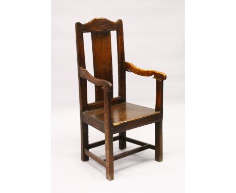 AN 18TH CENTURY OAK ARMCHAIR, with shaped cresting rail stamped with initials M W R N, plain splat, solid seat, on stretchere