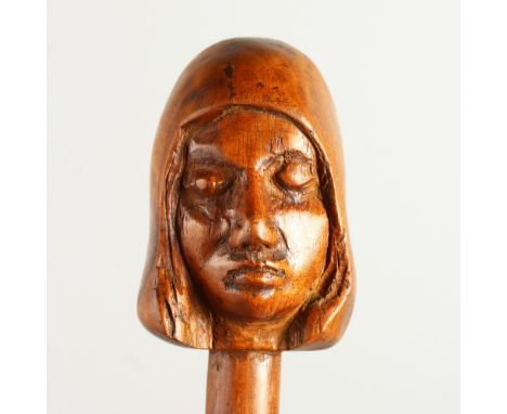 A 20TH CENTURY WALKING STICK, the handle carved as a head of a girl. 92cms long.