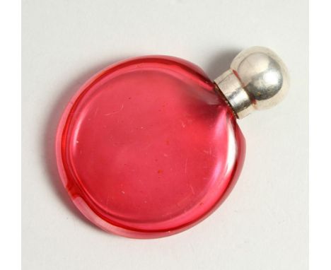 A VICTORIAN RUBY GLASS CIRCULAR SCENT BOTTLE with screw off silver cap. Birmingham 1895. Maker C. M. 4cms diameter.