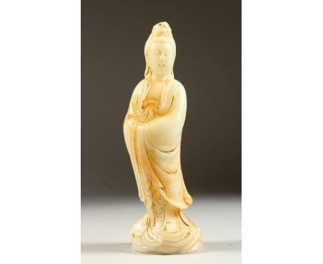 A CHINESE CARVED JADE FIGURE OF GUANYIN. 9ins high.