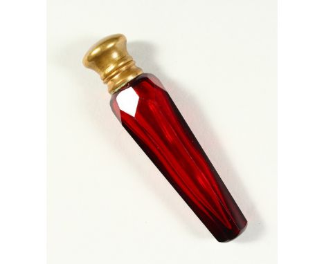 A VICTORIAN FACET CUT RUBY TAPERING GLASS SCENT BOTTLE AND STOPPER with plain cap. 10cms long.