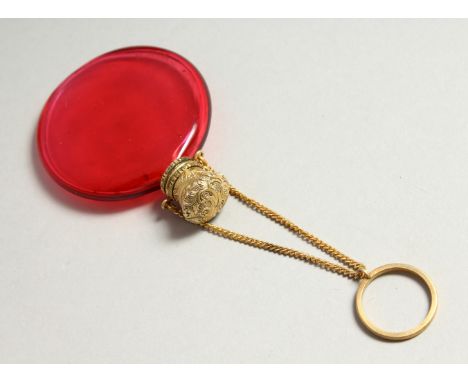 A VICTORIAN RUBY GLASS CIRCULAR SCENT BOTTLE with screw off silver gilt cap and chain. 4.5cms diameter.
