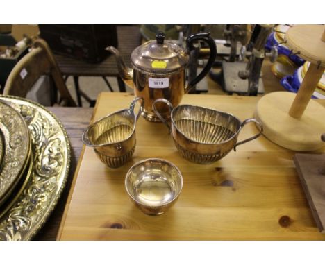 A silver plated teapot, two sugar bowls and a cream jug