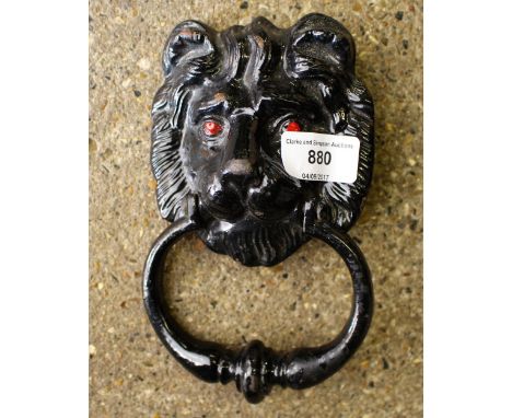 A black painted lion mask door knocker 