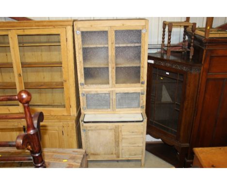 A stripped pine kitchen larder fitted with meat safe and sliding enamel drawer 