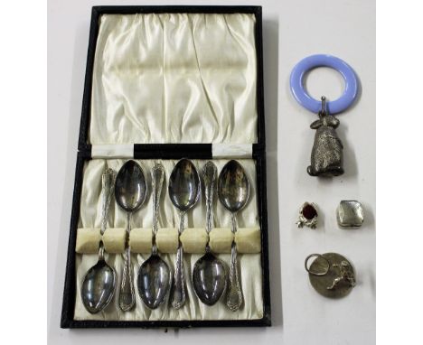 A box containing a cased set of six silver plated teaspoons, a silver plated baby's rattle, two scallop shaped salts, a small